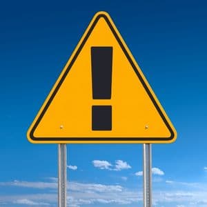 Yellow warning sign representing custom early warning financial indicators