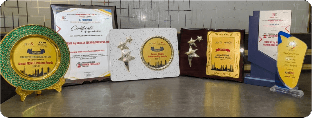 Finigenie award trophies and certificates including MSME Excellence Awards, MSME Sustainability Awards, and Promising Global Fintech Excellence Award